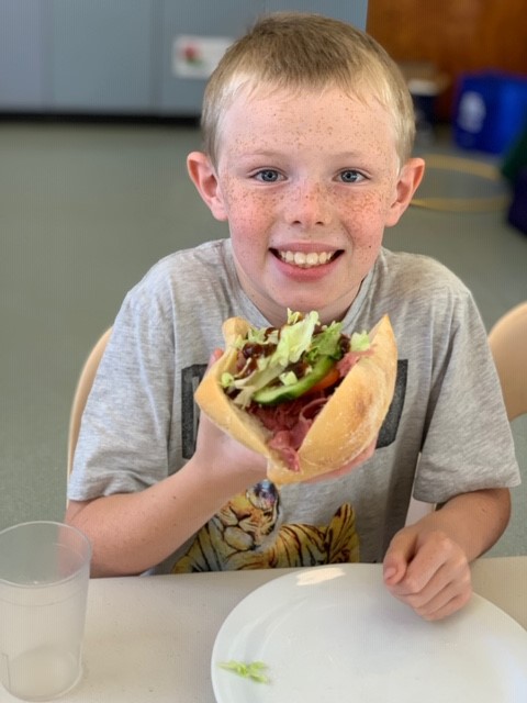 child eating a healthy salad roll