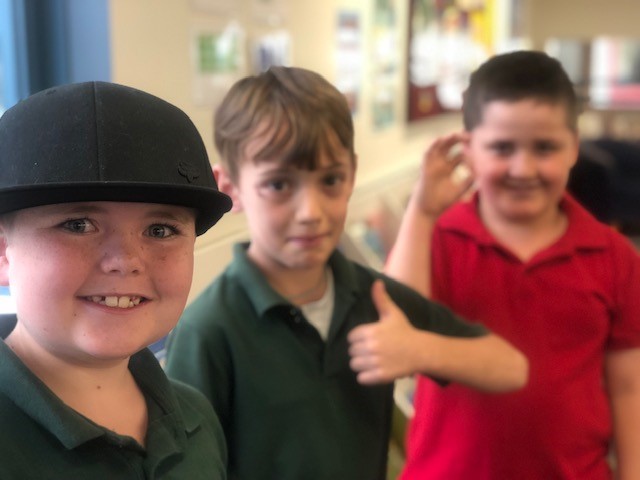 a photo of a boy in the library with friends