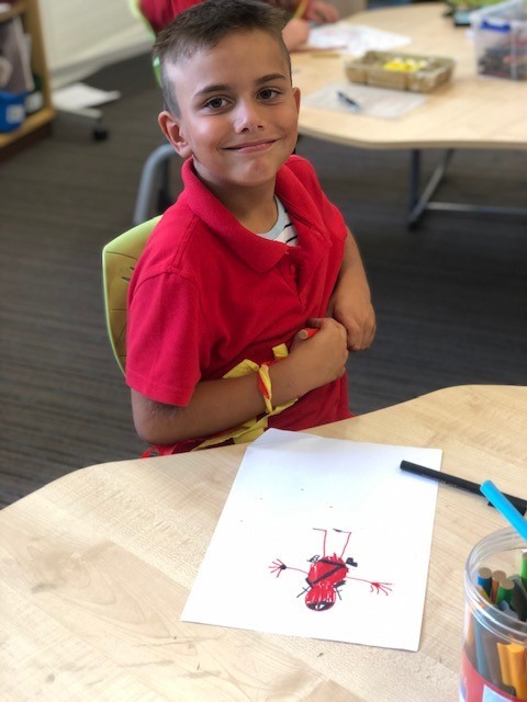 a photo of a year 2 boy writing