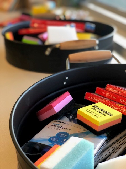 a photo of whiteboard erasers on a desk