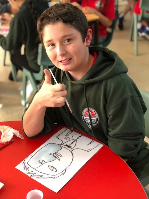 a photo of a child in year 5 painting