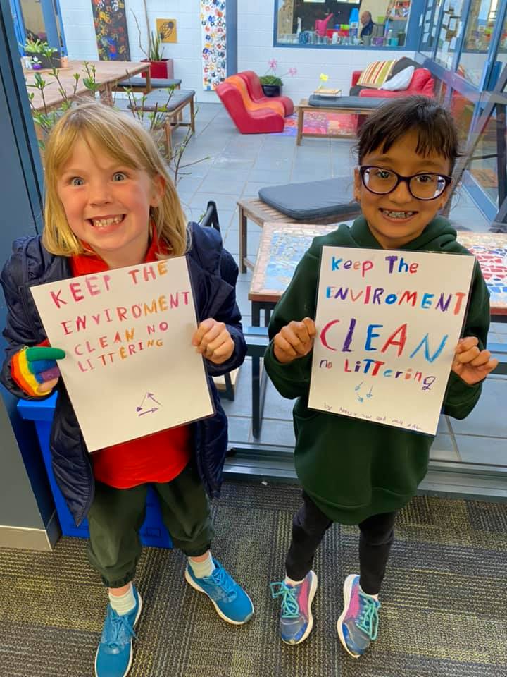 Children with environment posters