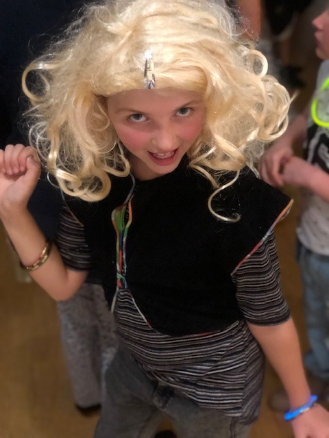 a photo of a child dancing at a school disco